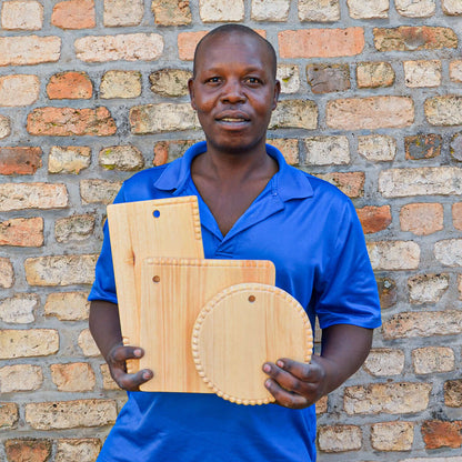 Artisan showing off hand-carved wooden serving boards